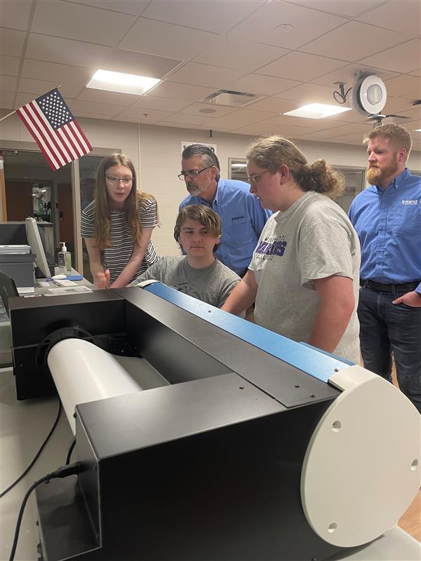 students looking at printer